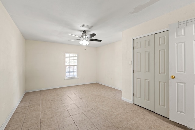 unfurnished bedroom featuring ceiling fan and light tile patterned floors