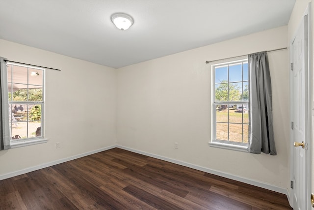 empty room featuring dark wood-type flooring