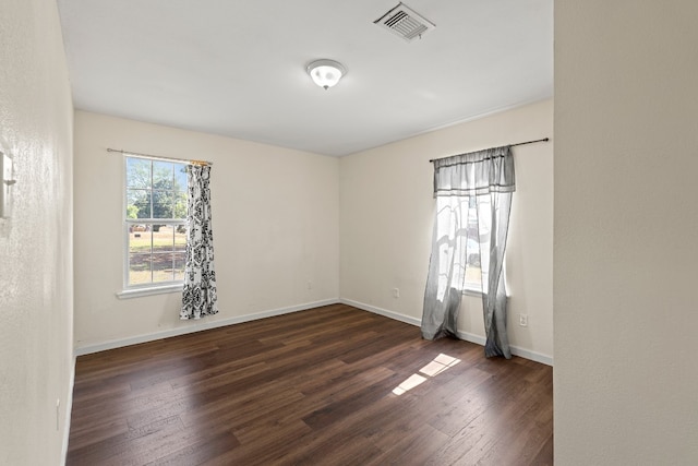 spare room with dark hardwood / wood-style flooring