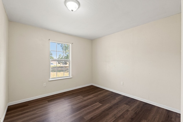 empty room featuring dark wood-type flooring