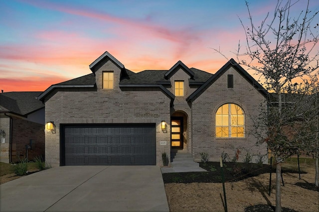 french country home featuring a garage