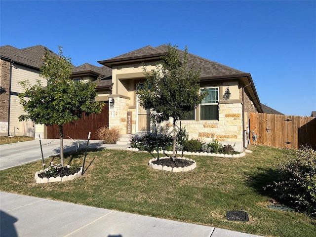 view of front of house with a front lawn and a garage