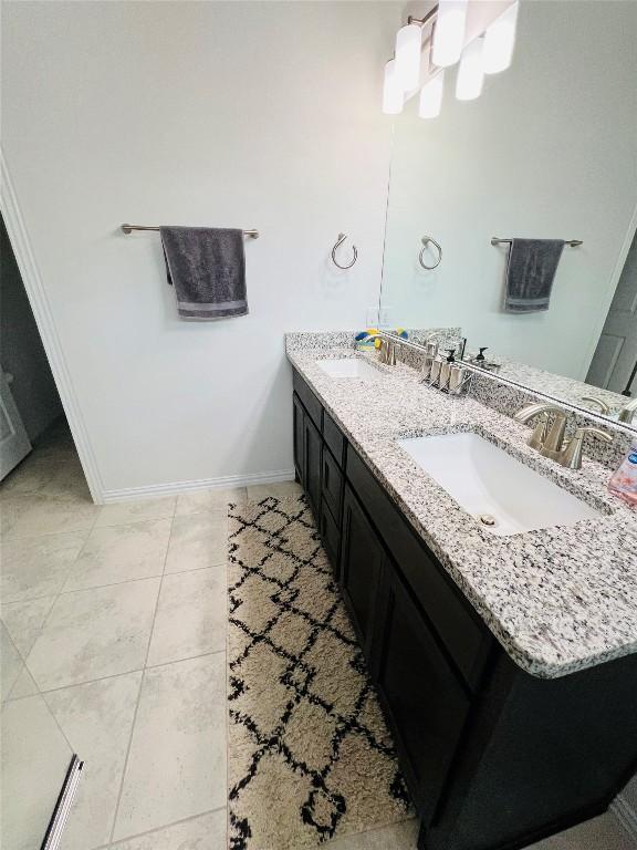 bathroom with tile patterned flooring and vanity