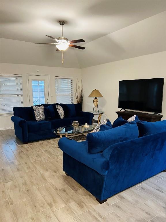 living room with ceiling fan and lofted ceiling