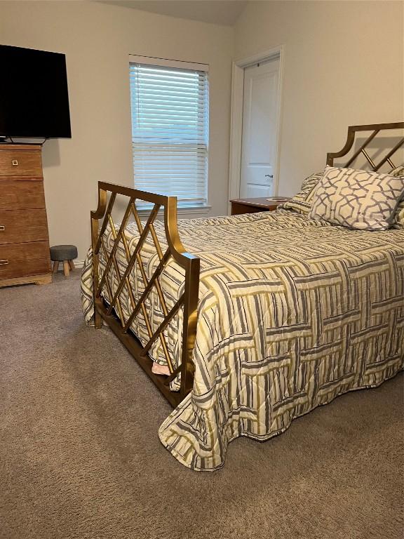 bedroom with lofted ceiling and carpet flooring