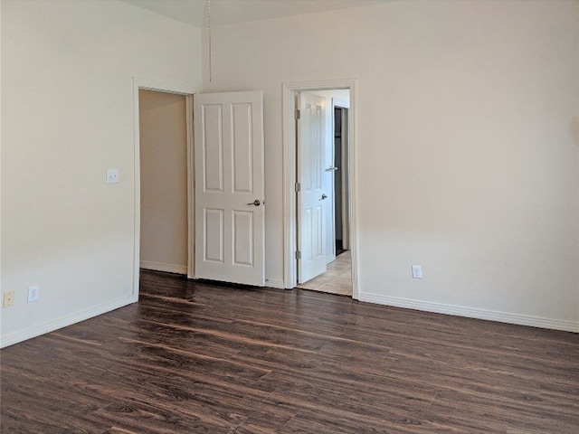 unfurnished room with dark hardwood / wood-style flooring