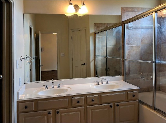 bathroom with bath / shower combo with glass door and vanity