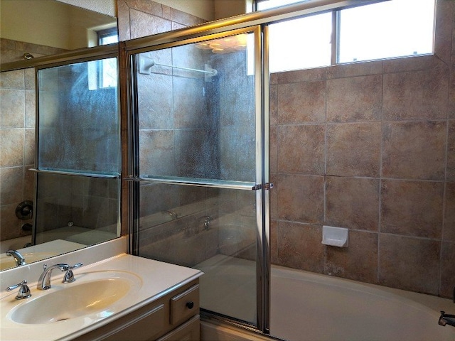 bathroom featuring vanity and shower with separate bathtub