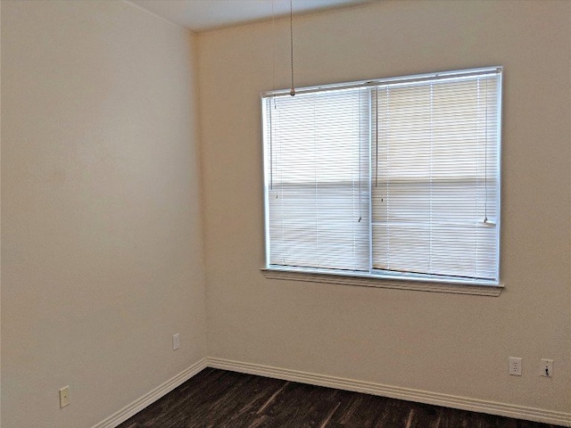 empty room with dark hardwood / wood-style floors