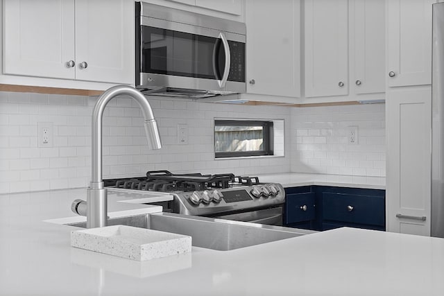 kitchen with white cabinetry and backsplash