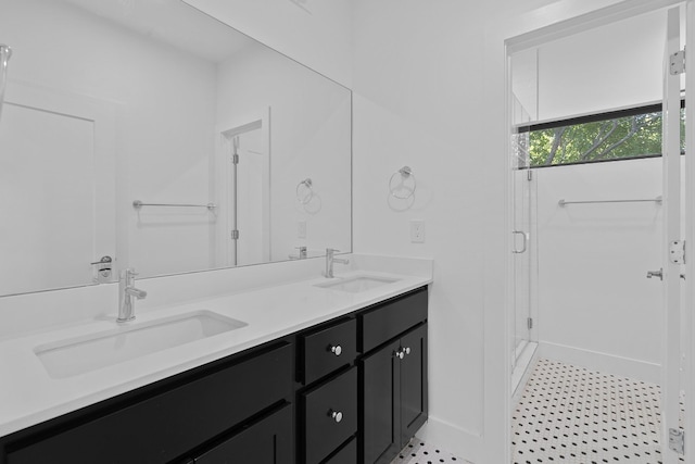 bathroom with vanity and a shower with door