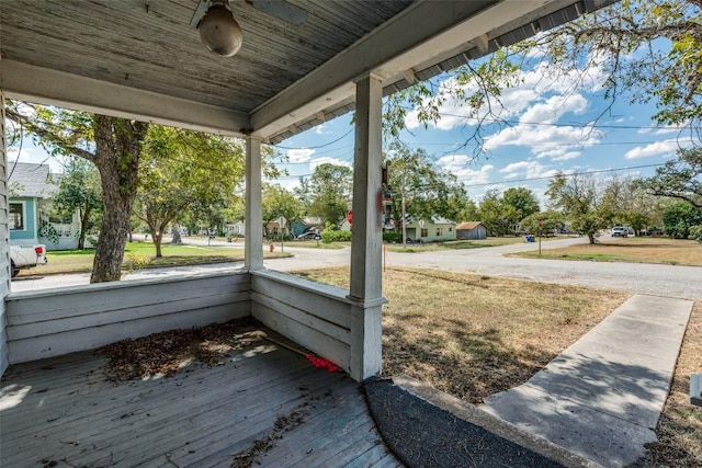 1504 Saint Peter St, Gonzales, TX 78629 - wooden porch with a ceiling fan and a lawn