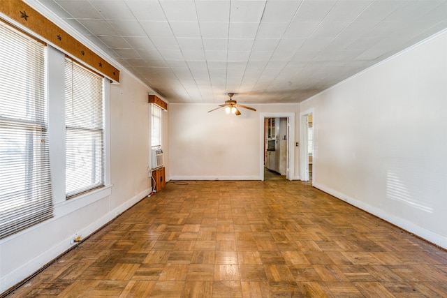 spare room with ornamental molding, light parquet floors, cooling unit, and ceiling fan