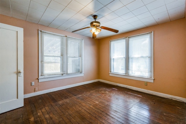 empty room with dark hardwood / wood-style floors and ceiling fan