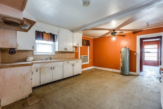 kitchen with gas water heater, white cabinets, and a healthy amount of sunlight