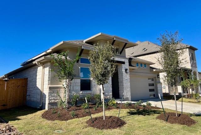 view of front of property featuring a garage and a front lawn