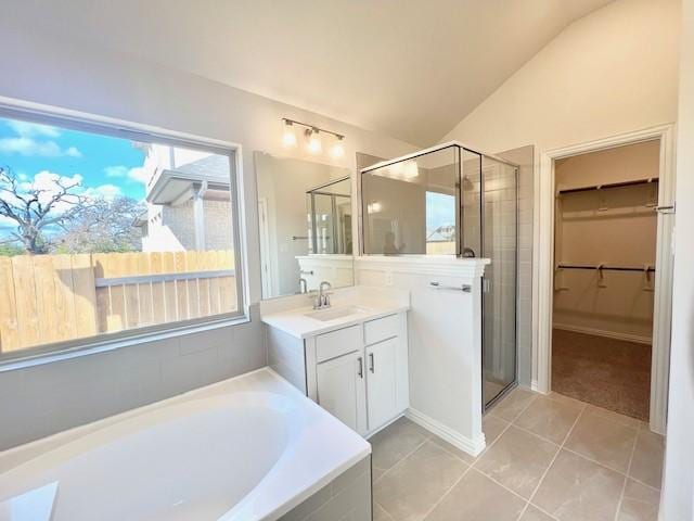 bathroom featuring tile patterned floors, vanity, vaulted ceiling, and independent shower and bath