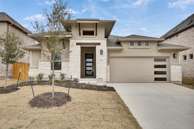 prairie-style house with a garage, stone siding, driveway, and stucco siding