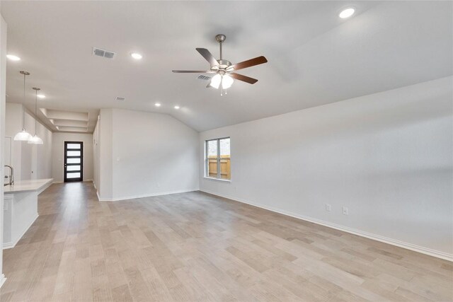 empty room with a ceiling fan, light wood-type flooring, visible vents, and plenty of natural light