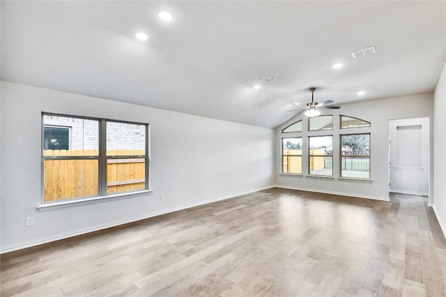 unfurnished room featuring lofted ceiling, ceiling fan, visible vents, and wood finished floors