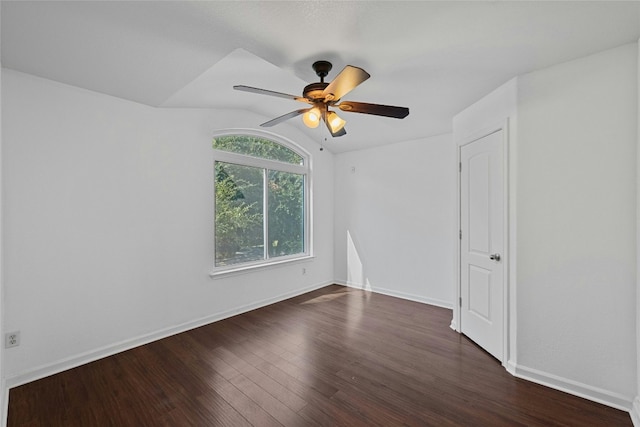 unfurnished room with ceiling fan, lofted ceiling, and dark hardwood / wood-style floors