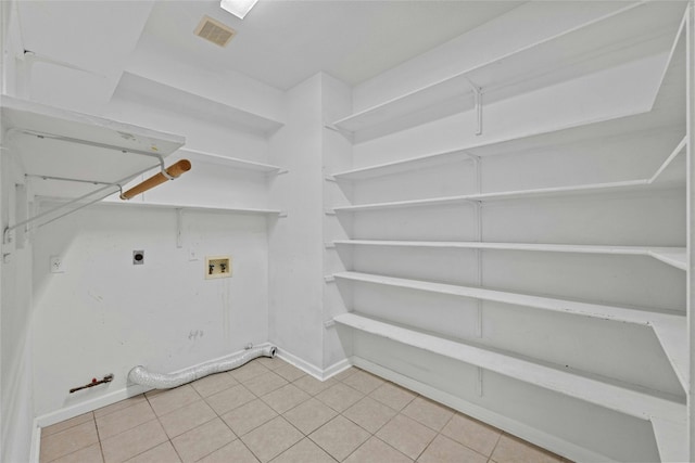 laundry area featuring hookup for an electric dryer, hookup for a washing machine, hookup for a gas dryer, and light tile patterned floors