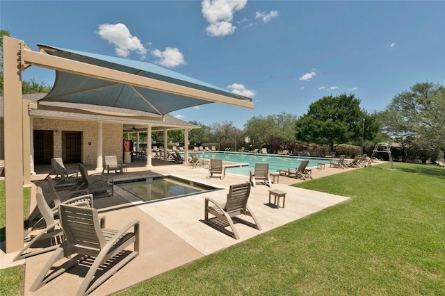 view of swimming pool with a patio and a yard