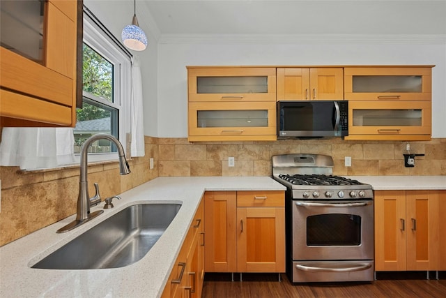 kitchen featuring pendant lighting, dark hardwood / wood-style flooring, sink, ornamental molding, and appliances with stainless steel finishes