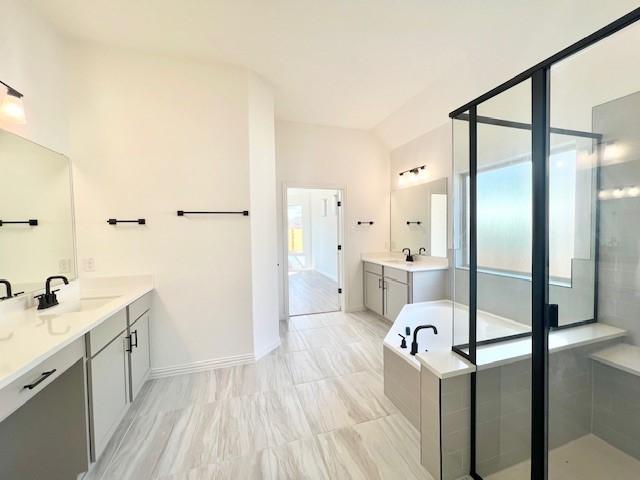 bathroom with vanity, separate shower and tub, and plenty of natural light