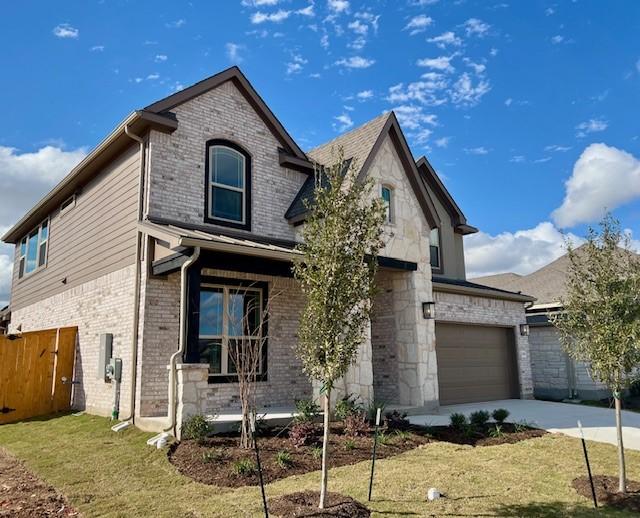 view of front of house featuring a front yard and a garage