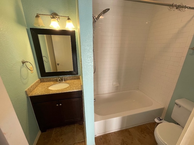 full bathroom featuring tiled shower / bath combo, vanity, and toilet