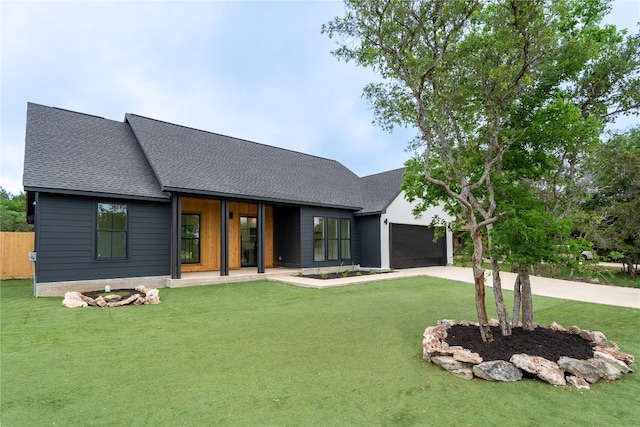 view of front of house with a garage and a front yard