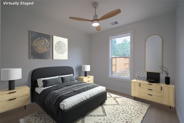 bedroom with ceiling fan and dark hardwood / wood-style flooring