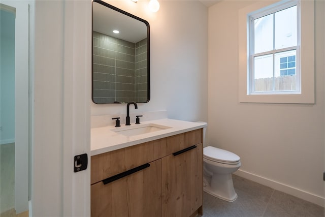 bathroom with vanity, tile patterned flooring, and toilet