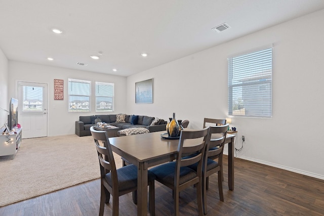 dining space with dark hardwood / wood-style flooring