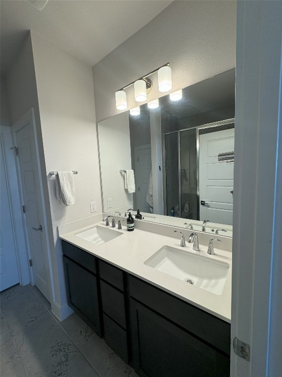 bathroom featuring vanity and an enclosed shower