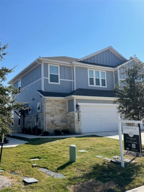 view of front of property featuring a garage and a front lawn