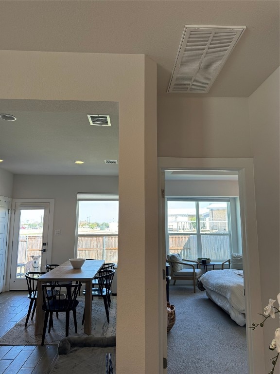 carpeted dining area featuring plenty of natural light