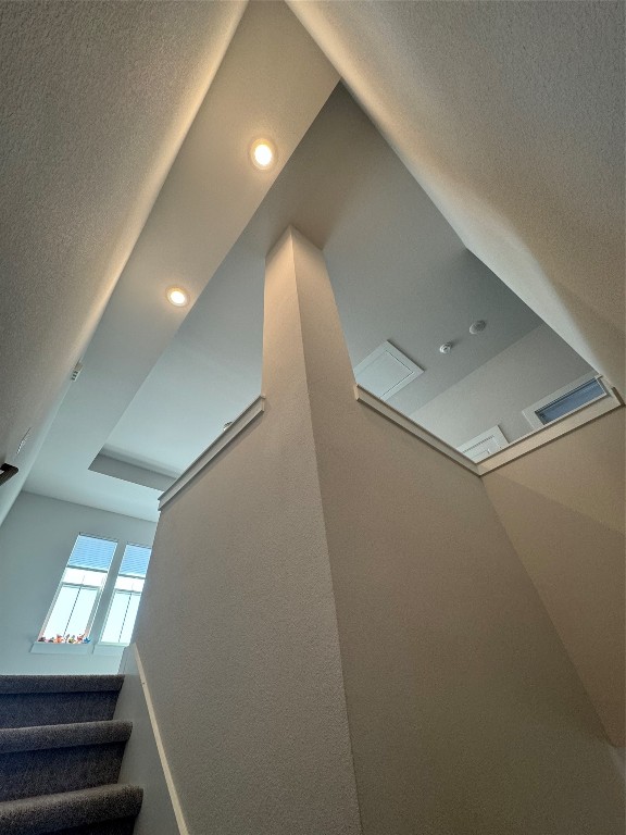 staircase with a textured ceiling