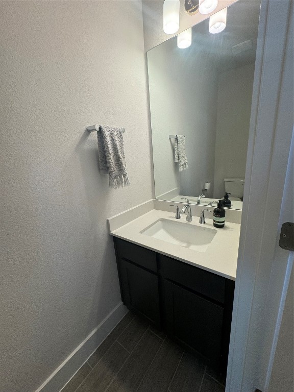 bathroom with vanity and toilet