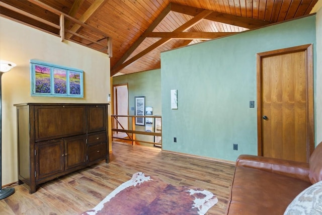 living room with lofted ceiling with beams, wooden ceiling, and light hardwood / wood-style flooring