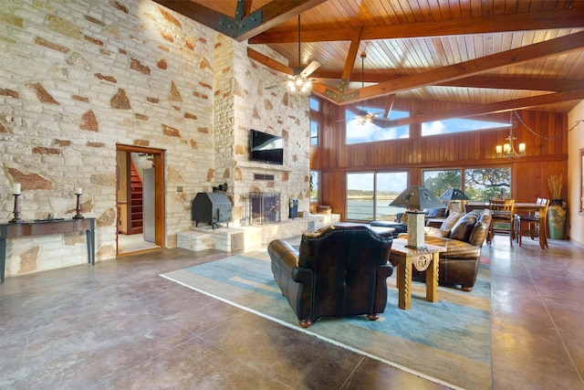 living room with wood ceiling, ceiling fan with notable chandelier, beam ceiling, high vaulted ceiling, and a stone fireplace