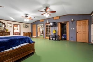 bedroom featuring ceiling fan and vaulted ceiling