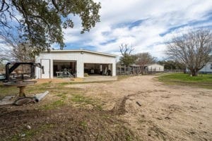 view of yard with a garage and an outbuilding