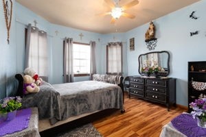 bedroom featuring hardwood / wood-style floors and ceiling fan