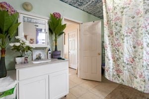 kitchen featuring white cabinets and light tile patterned floors