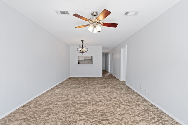 unfurnished room featuring light carpet and ceiling fan with notable chandelier