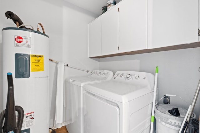 laundry room with cabinets, water heater, washer and dryer, and hardwood / wood-style flooring