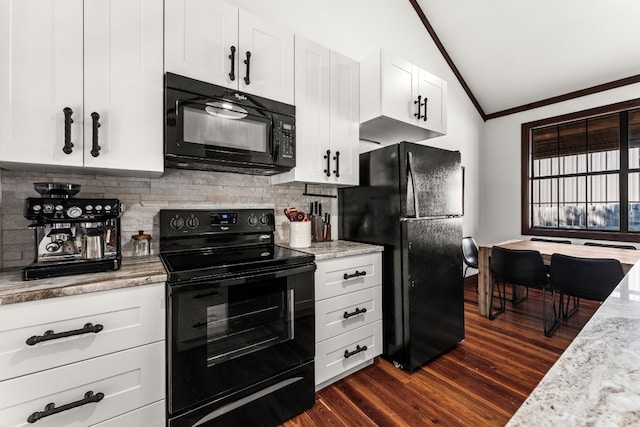 kitchen featuring dark wood-type flooring, lofted ceiling, light stone countertops, black appliances, and white cabinetry