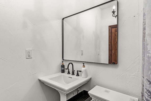 bathroom featuring sink and toilet